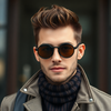 Attractive man wearing modern clothes with steampunk round sunglasses on